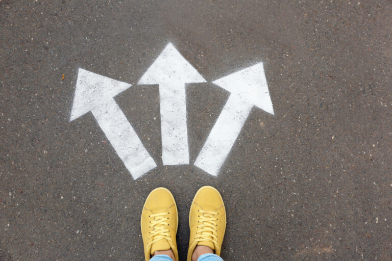 Woman,Standing,Near,Arrows,On,Asphalt,,Top,View